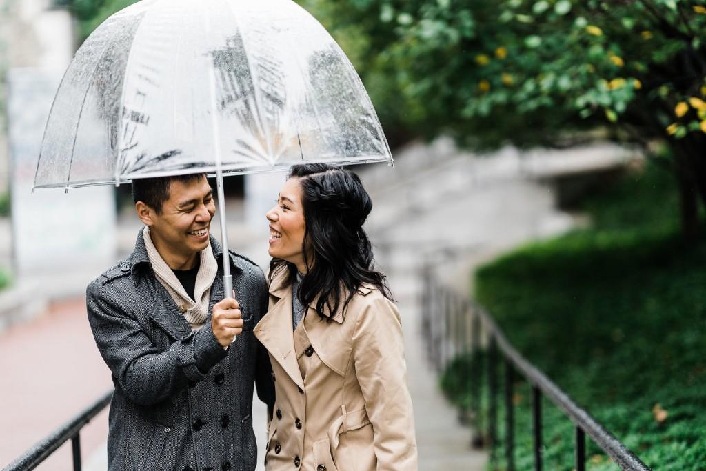 Couple with umbrella in rain during engagement shoot, J&J Studios