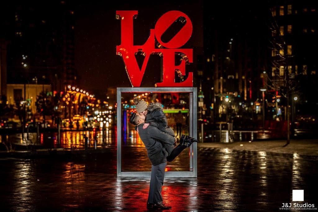 bride and groom at love statue in philadelphia