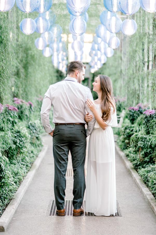 couple looking at each other in longwood gardens by clicke photography and philly in love blog