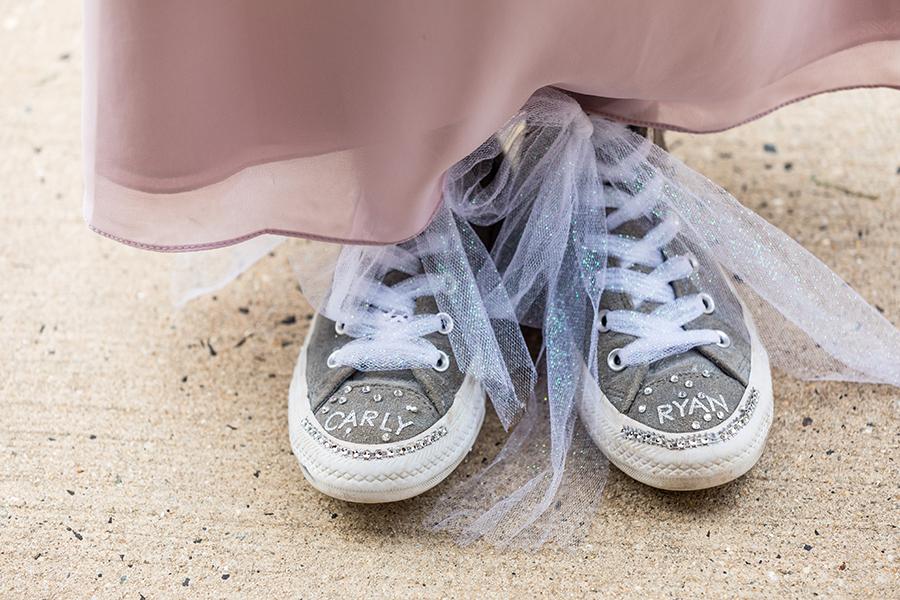 bridesmaid wearing sneakers decorated with names of bride and groom by ashley gerrity photography and philly in love