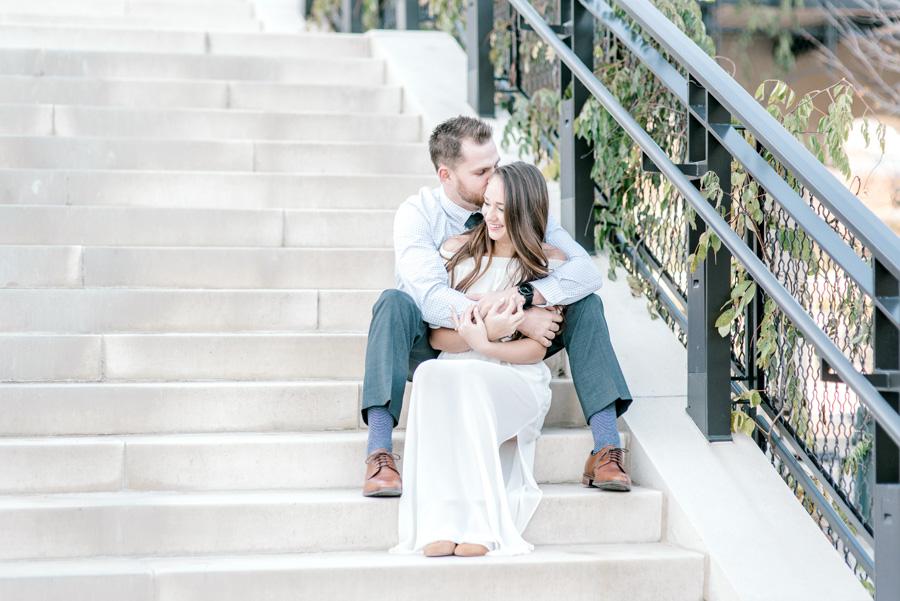 couple sitting on steps embracing by clicke photography and philly in love blog