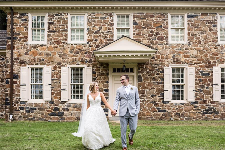bride and groom holding hands at historic wayne house philly in love blog