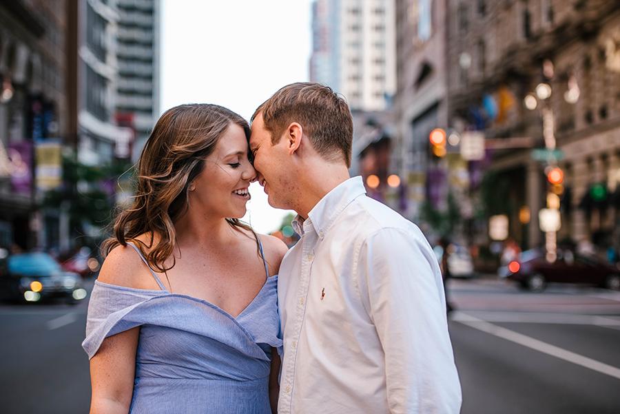 engaged couple kiss on city street by Nicole Cordisco Photography and Philly In Love