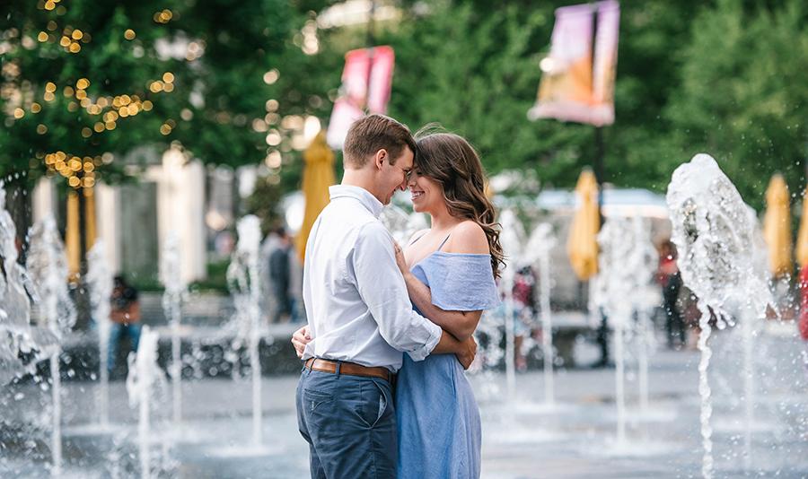 couple embrace in water fountains at Dilworth Plaza by Nicole Cordisco and Philly In Love