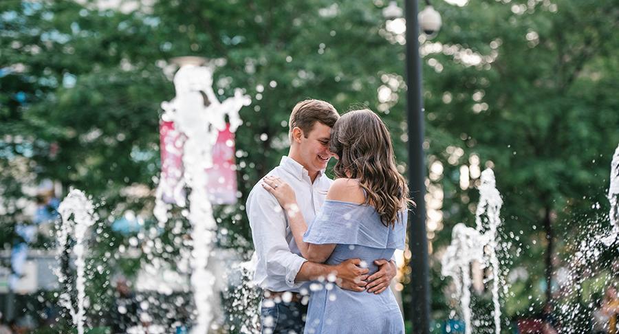 couple at embrace in fountains at Dilworth Plaza by Nicole Cordisco Photography and Philly In Love