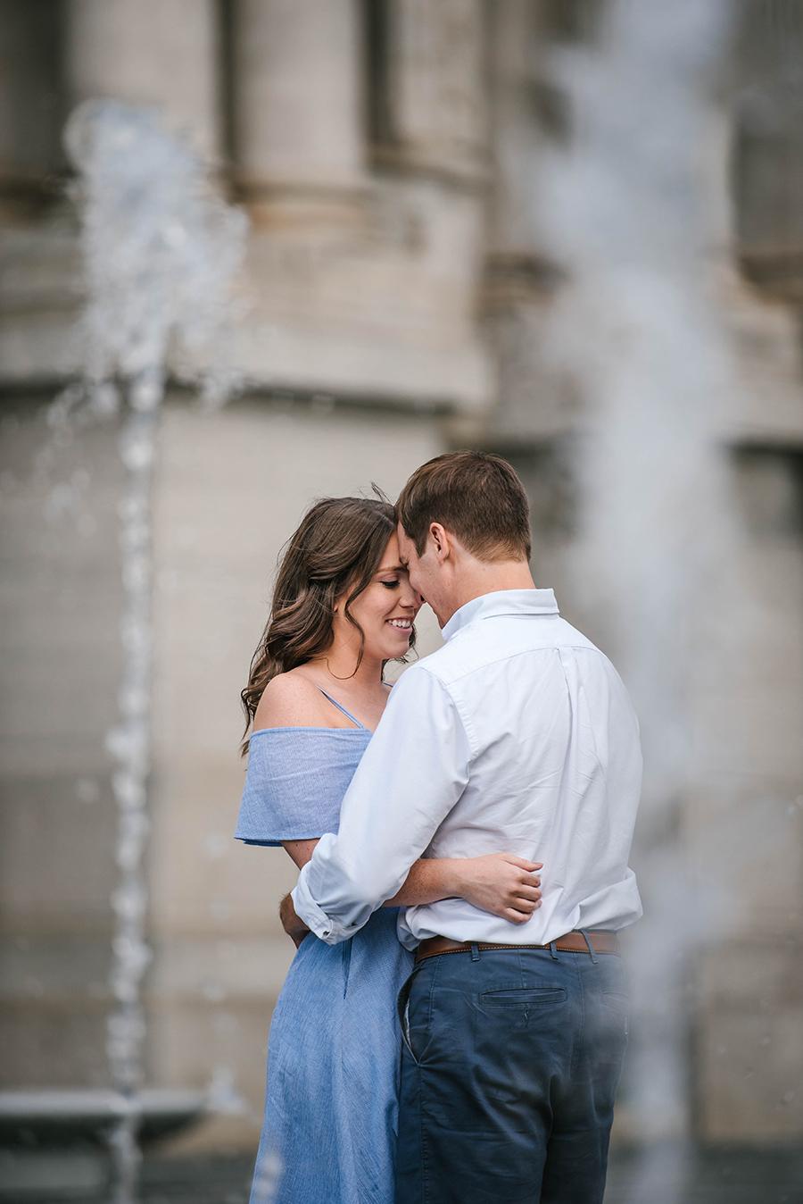 couple embrace in fountains at Dilworth Plaza by Nicole Cordisco Photography and Philly In Love