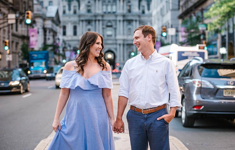 couple holding hands in front of Philadelphia City Hall by Nicole Cordisco Photography and Philly In Love