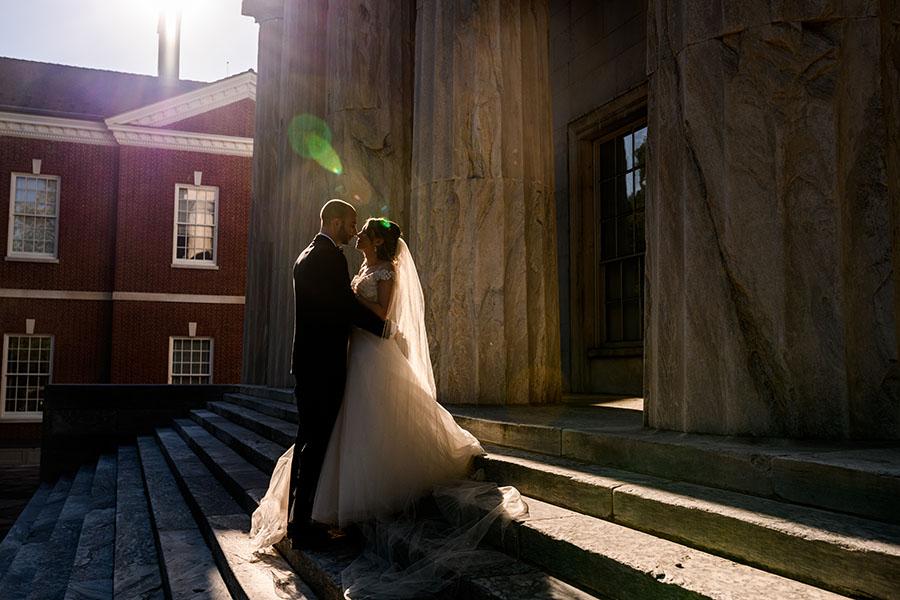 couple kissing on second bank's steps bank by daniel moyer photography
