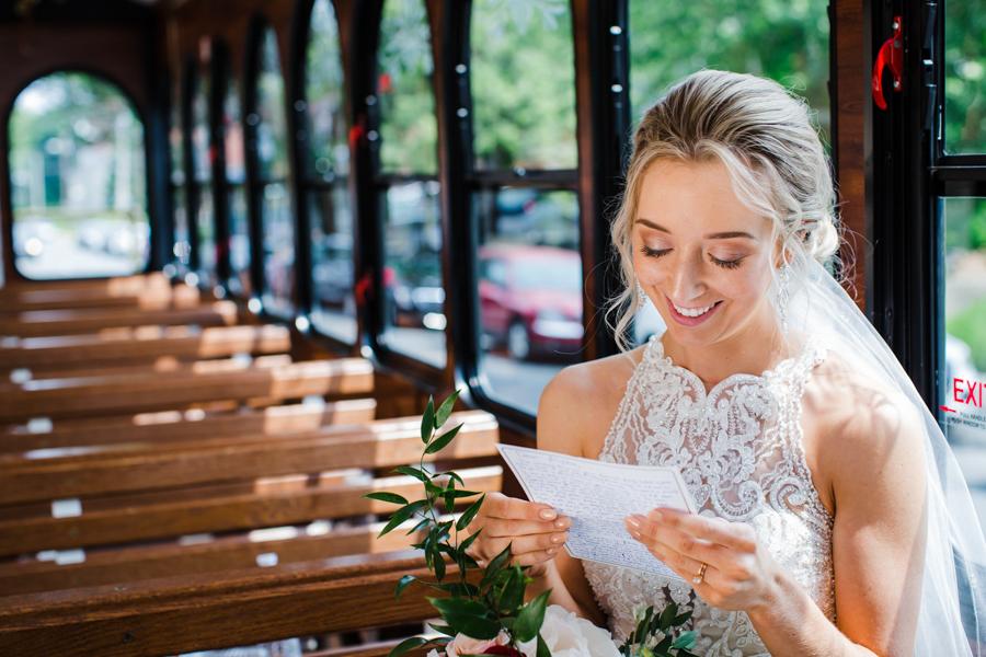 bride reading letter on trolley