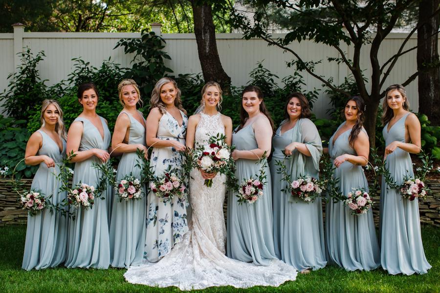 bride and bridal party holding flowers by Daniel James Studios