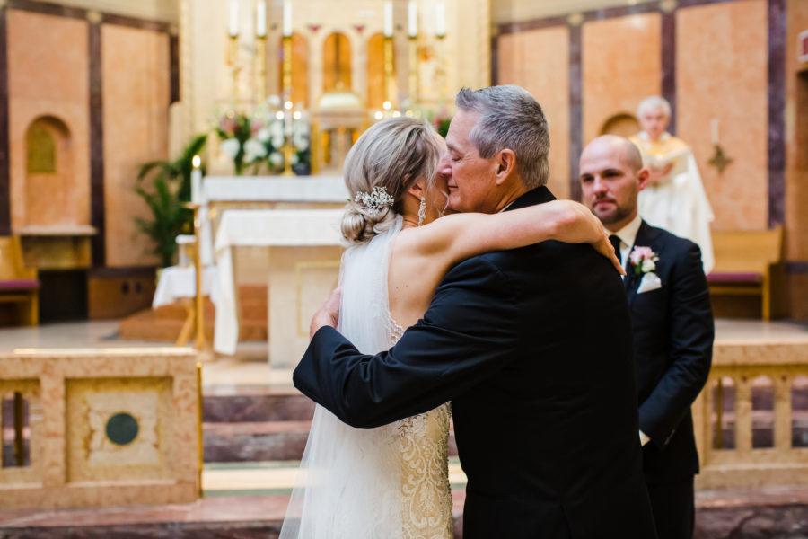 bride and father hugging in church