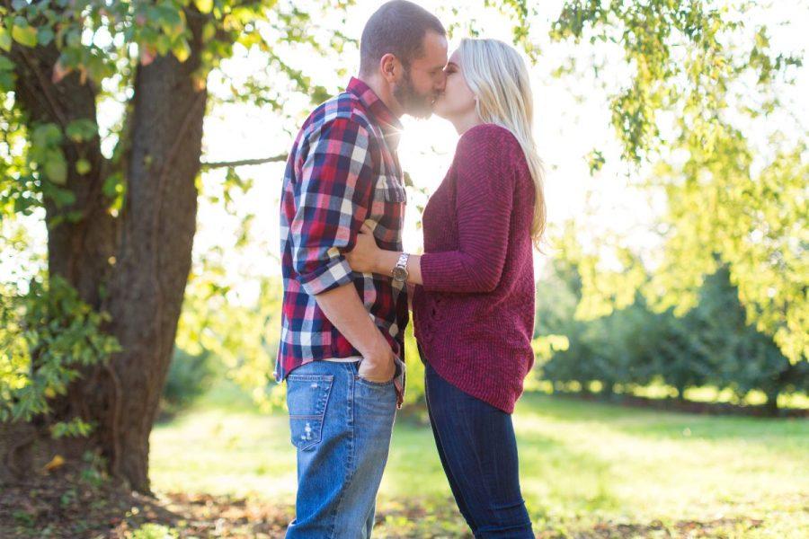 couple kissing in vineyard