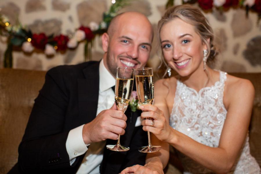 married couple toast with champagne at wedding reception
