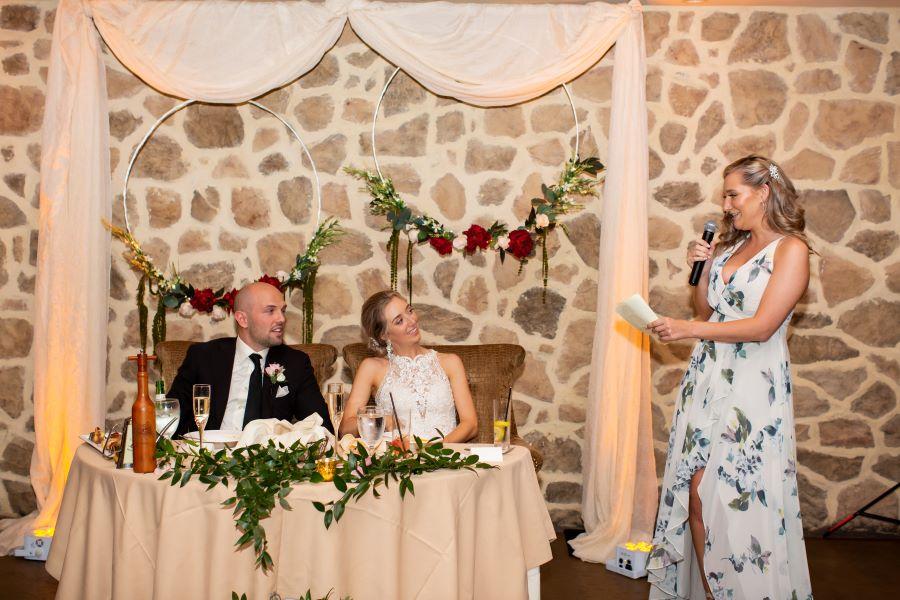 couple seated at sweetheart table at wedding reception