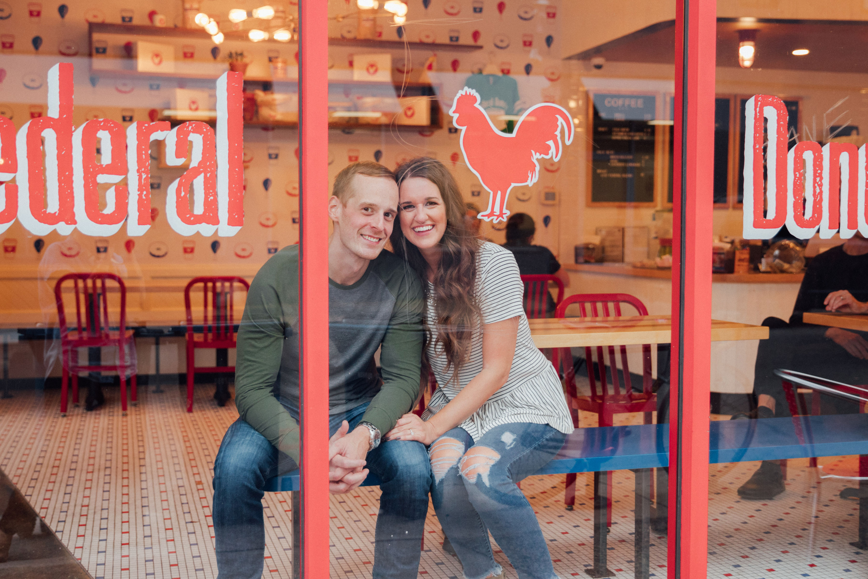 couple sitting inside of donut shop