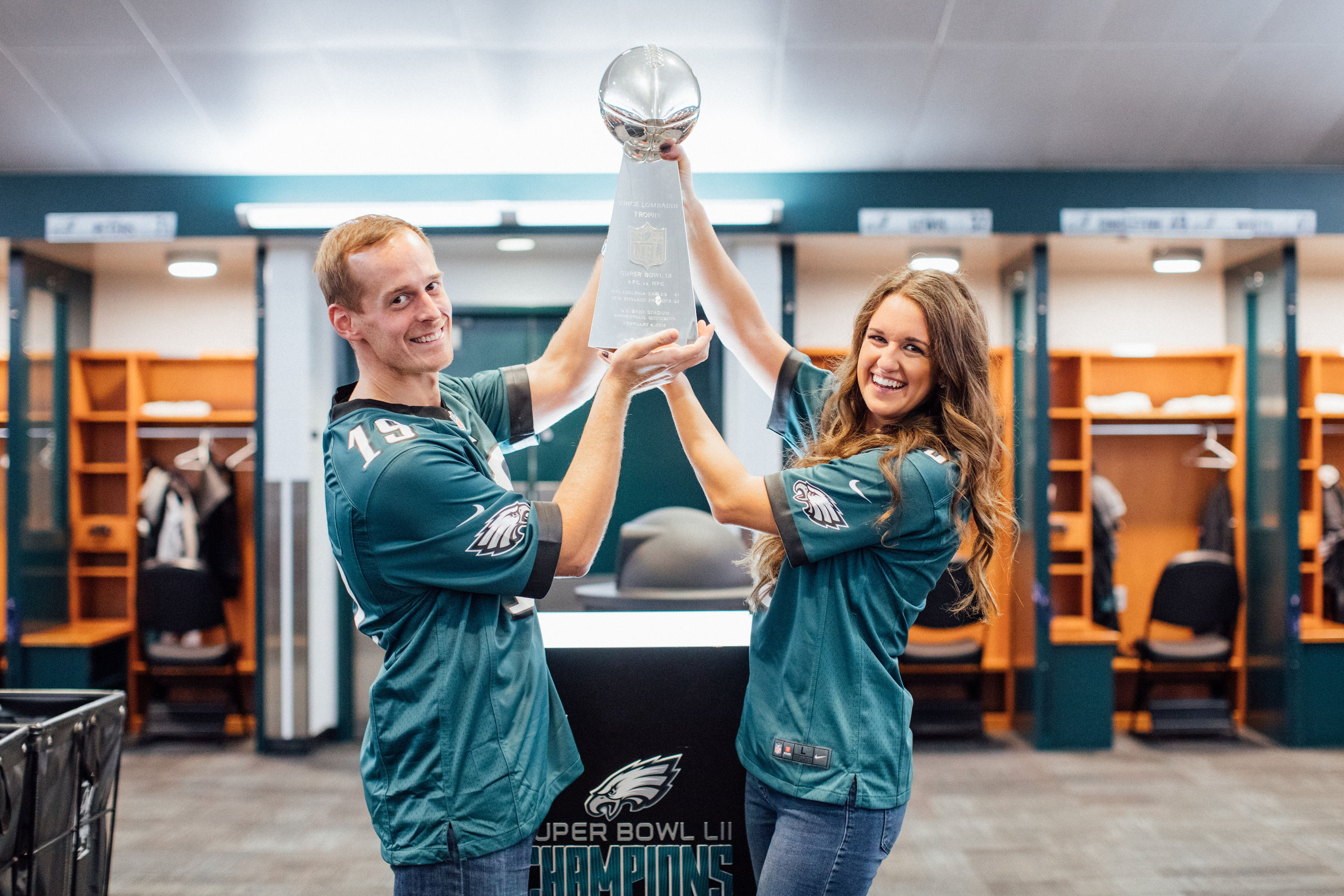 couple holding football trophy