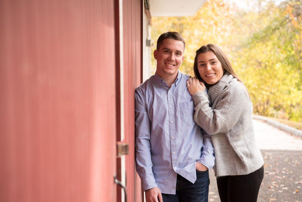 couple standing by barn outside