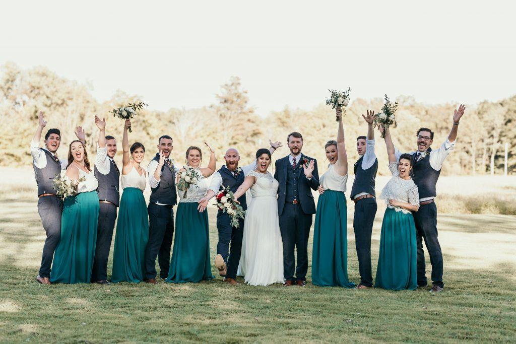 bridal party at farm wedding with married couple