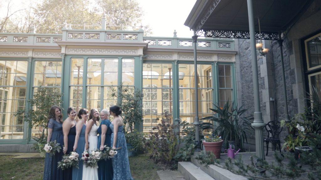 bride and bridesmaids pose outside with bouquets