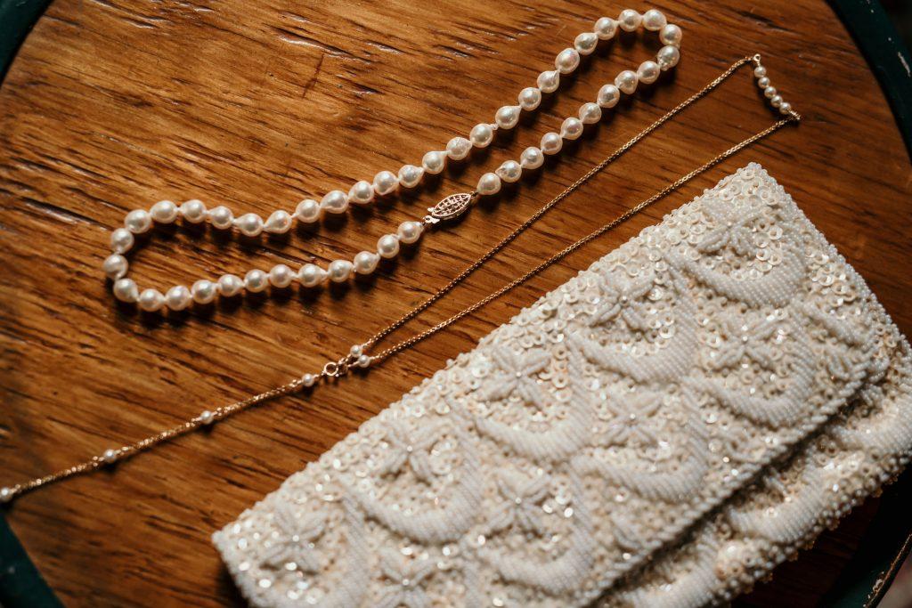pearl necklace and beaded clutch
