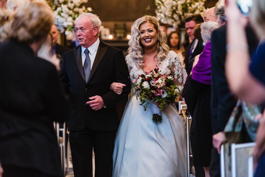 bride coming down aisle with father
