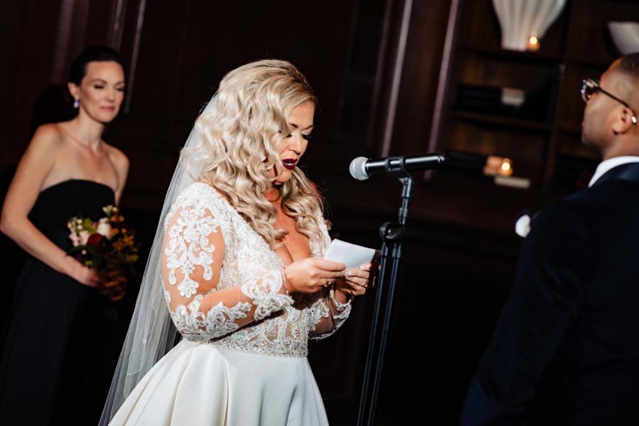 bride reads her vows to her groom