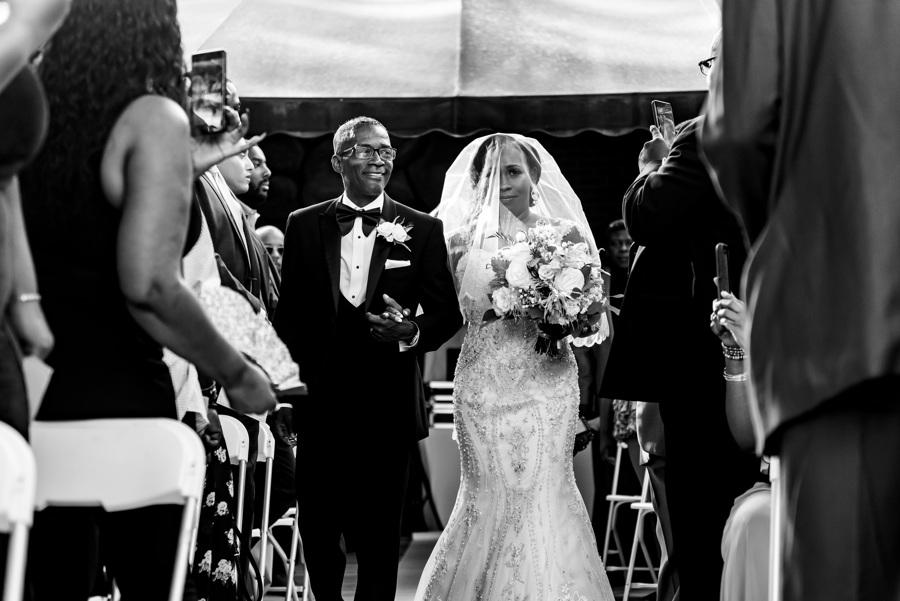bride escorted by her father down the aisle