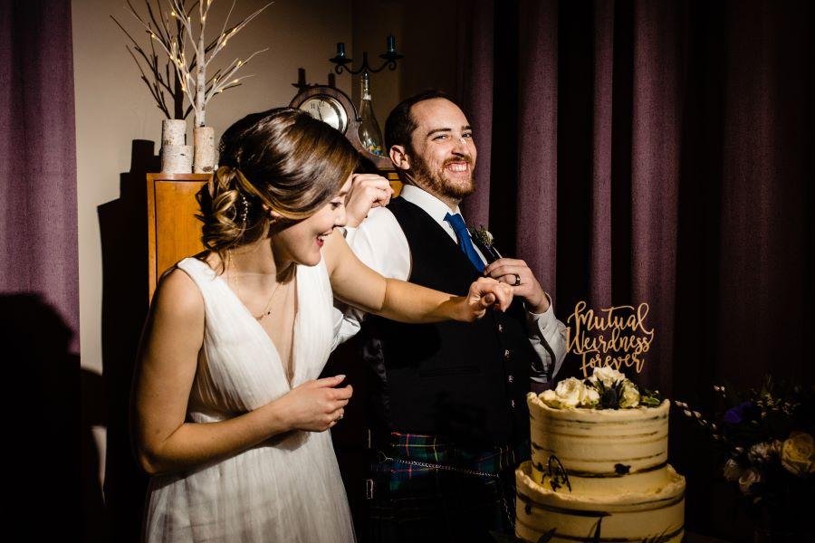 bride and groom eat wedding cake