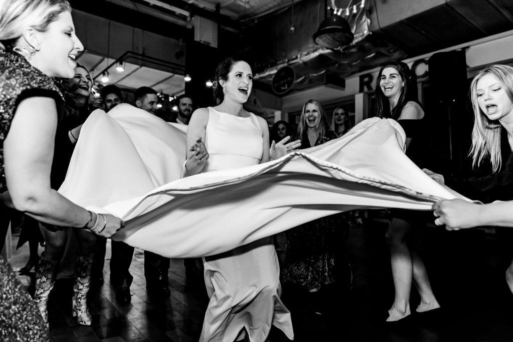 bride and guests dance at wedding reception